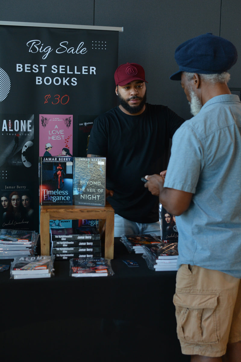 Two men interacting at a book stall with bestseller books on display.