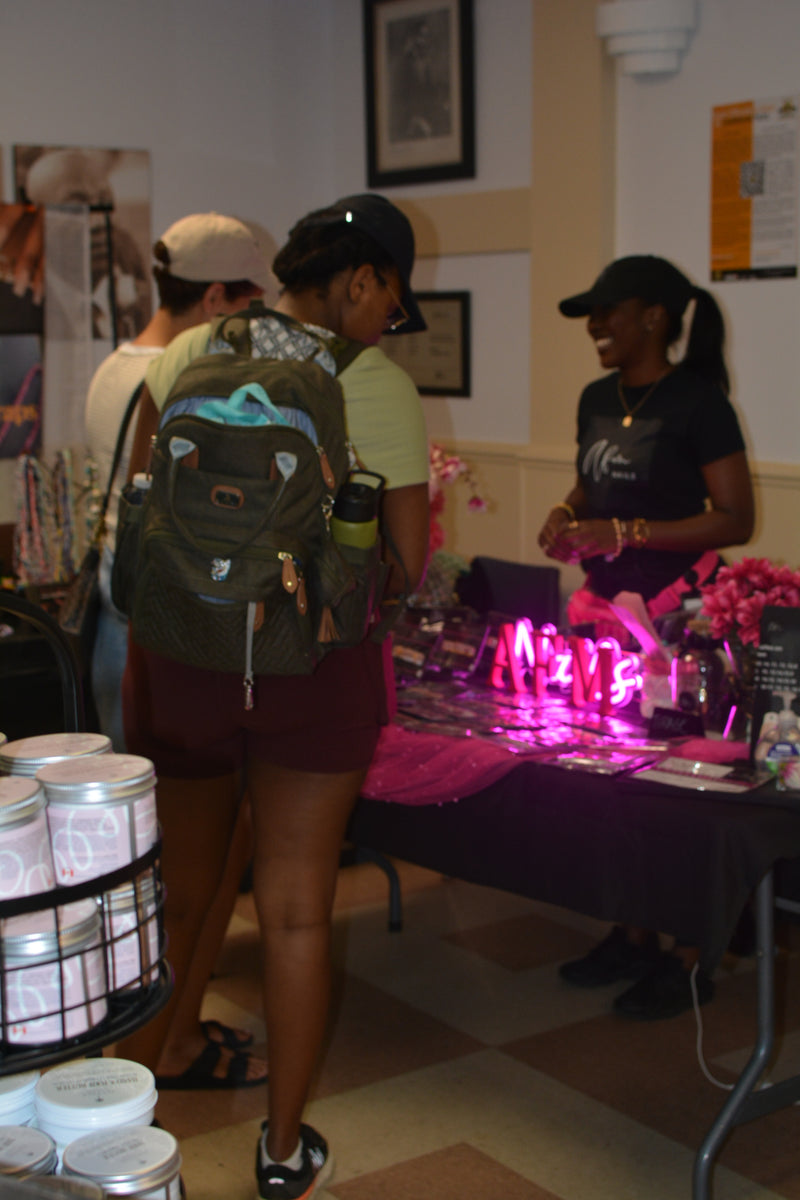 People interacting at a table with products and decor in a casual setting