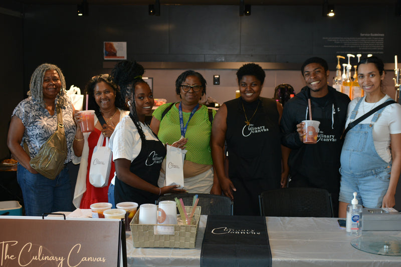 Group of people posing together at an event with 'The Culinary Canvas' branding.